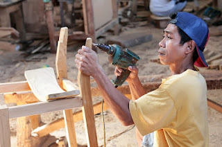 pengrajin kayu sedang melakukan teknik bor