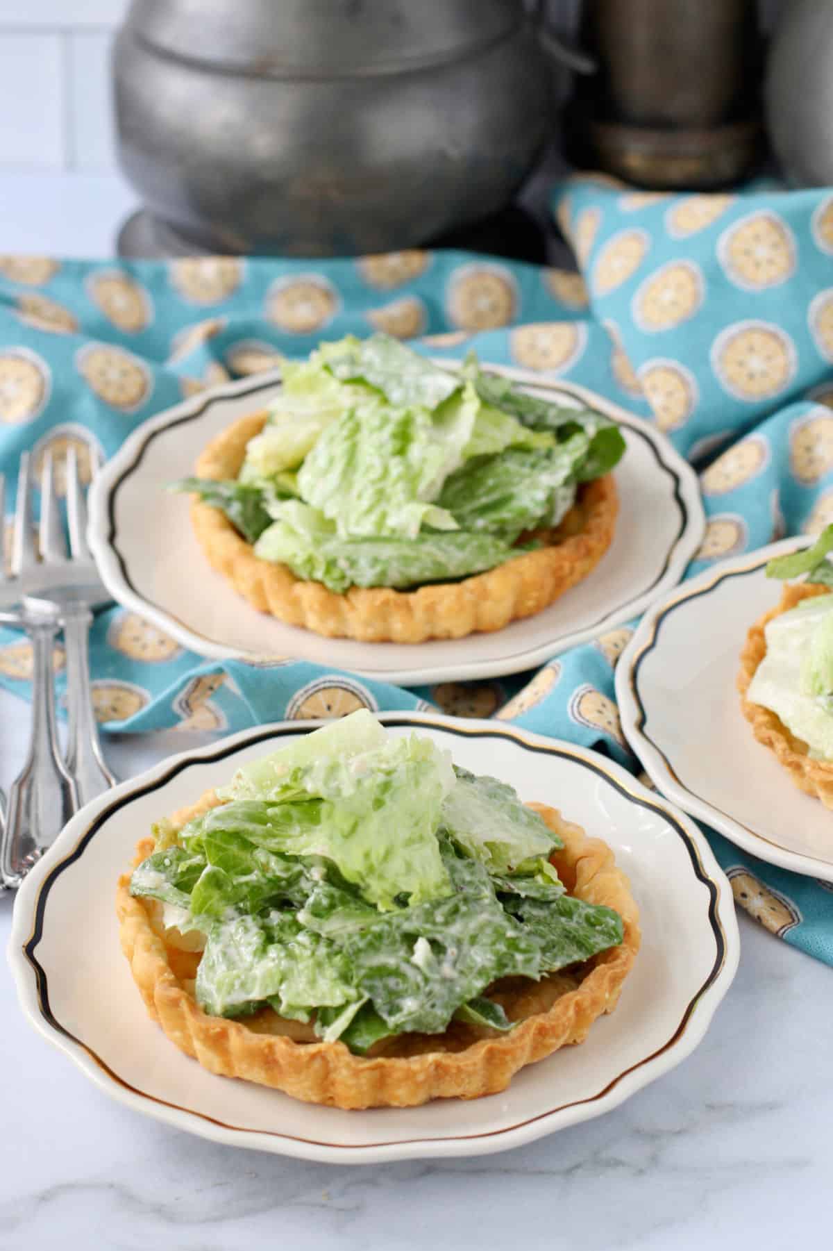 Caesar Tartlets with Sweet Garlic Butter Crusts on plates.