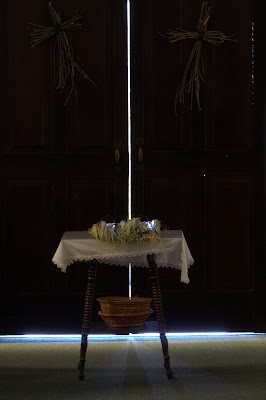 Table of palm leaves in front of church doors