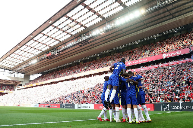 Chelsea players celebrate a goal against Liverpool at Anfield