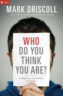 Book cover with a man holding title in front of his face. 