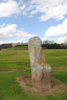 A photo showing a slightly phallic looking standing stone with Huly Hill Cairn in the background.  Photo by Kevin Nosferatu for the Skulferatu Project.