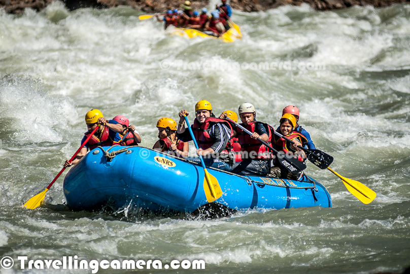 Rafting or white water rafting is one of the challenging recreational outdoor activity using an inflatable raft to navigate a river or other bodies of water having different levels of water-current. This is usually done on white water or different degrees of rough water, in order to thrill and excite the raft passengers. Rafting is considered an extreme sport, as it can be dangerous as times. This Photo Journey shares some of the photographs of Rafting in Risikesh, which is one of the popular places in India to do White Water Rafting.Recently we were in Rishikesh with office friends and Rafting was one of the top item in our list of things we wanted to do. We started in bus from Aspen Camps in Rishikesh and then boarded to jeeps with rafts. We had to start from Marine Drive which is a huge Ganges beach with enough space for folks to prepare and get started. Marine Drive is a place, strategically identified to start Rafting. Shivpuri is another preferred place to start Rafting. Idea is to make people comfortable with various types of water-rapids and then gradually start enjoying various stretches in river. Ganges provides a good range of water rapids and makes rafting an unmatchable experience.Rishieksh is one of the main places to do rafting in North India. Long time back I had done rafting in Vyas River near Kullu and that time all other rafters were professionals and I was covering a particular camp for Tourism Development program. Since I was not much involved in rafting activities, I couldn't enjoy it much that time. At Rishikesh, we had a wonderful coach/leader, who made rafting experience as great fun.After reaching Marine Drive Ganges beach, everyone of us got life jackets, a pedal and helmet. All three important things were with us and coach told us the best ways of using these three. All set with tight life-jacket, well settled helmet and appropriately gripped pedals we stepped into the raft after cleaning our feet in ganges water. It's recommended not to bring sand particles inside the raft, which can harm later. The coach threw chilling ganges water on us to start the journey in chilled water of ganges with different current levels. Coach with one of other Rafting professional entered into the raft. Then he briefed everyone of us about different commands like fast forward, move backward, stop etc. Initially it was difficult for us to gram every details of each command, but every command was very important for best rafting experience.Apart from basic Rafting commands, coach/leader also tells about basic rules of White Water Rafting. He also understands about each person sitting in the raft about their past experience with water. He also shares some basic steps for people who are not comfortable while sitting in raft. Of course, there are some standard rules to sit on a raft and make yourself comfortable even when body needs to stick with raft through feet in a particpular position. The Thumb rule is to listen your coach and follow him without any alternation, even in difficult situation. Idea is to trust the coach/Leader and follow his/her commands with any panic.So we started with baby steps and raft started moving towards Rishikesh (Lakshman Jhoola). For first 10 minutes, we were really slow and it was more of practice session, wehere coach was making us prepared for following his commands throughout the whole stretch we had to do in river. After practicing all the commands and moving our raft in circle, coach/leader asked us to stand on boundaries of raft and balance with pedal mounted on raft top. None of us could gather courage to stand on the boundaries and negotiated with coach/leader to stand inside the raft and try to balance with pedals. It was one of the major test for us and raft moves a lot. Many times, some of us stumbled and others were getting impacted because of imbalance. This task completed and coach/leader asked us to move forward.First we encountered Good Morning Rapid which is the beginning of Rafting experience. Good Morning rapid always come of the way and it doesn't matter that what was your starting point :). It was very basic but yet exciting because of first encounter with relatively fast flow of water-waves. Before hitting the rapid, some of the screaming while others were laughing to hide the fear :)All these photograph in this Photo Journey are clicked day before we did rafting. One day before we did rafting, we kept going to different places around river bed to shoot rafts sailing through high rapids of Ganges white water. Above photograph shows one of the raft getting up side down at Golf Course. One of the other leader jumped into the water to rescue raft and then every rafter. Within 5-8 minutes everyone was back on top of raft and moved forward towards Laxman Jhoola, which was end point. In such situations, ideally, everyone should listen carefully to what leader says and follow with panic. Things can get worse in case of avoidance of leader commands.The modern rafts are inflatable boats, consisting of very durable, multi-layered rubberized (hypalon) or vinyl fabrics (PVC) with several independent air chambers. The length varies between 3.5 meters and 6 meters, the width between 1.8 meters and 2.5 meters. The exception to this size rule is usually the packraft, which is designed as a portable single-person raft and may be as small as 1.5 metres long and weigh as little as 1.8 kilograms.Rafts come in a few different forms. In Europe and Australasia, the most common is the symmetrical raft steered with a paddle at the stern. Other types are the asymmetrical, rudder-controlled raft and the symmetrical raft with central helm (oars) or Stern Mounts with the oar frame located at the rear of the raft. Rafts are usually propelled with ordinary paddles and or oars and typically hold 4 to 12 persons. In Russia, rafts are often hand made and are often a catamaran style with two inflatable tubes attached to a frame. Pairs of paddlers navigate on these rafts. Catamaran style rafts have become popular in the western United States as well, but are typically rowed instead of paddled.Check out more at - http://en.wikipedia.org/wiki/RaftingAfter Good-Morning rapid, we crossed - Black Money, Three Blind Miles, Cross Fire, Shivpuri, Return to center, Roller Coaster, Tea off, Golf Course, Club House, Initiation, Body Surfing, maggie point & Cliff jumping, Double Trouble, Hilton and fianally Ram Jhoola. I went till Golf Course only and most of the other rafts from our group ended at Lakshman Jhoola.The most suitable time for River Rafting in Rishikesh is from September to November and from March to April-May. One of the best rivers in the world to experience the sheer exhilaration of white water rafting, it is the sheer invincible power of the Ganga river that often attracts the adventurer to the challenging sport of river rafting at Rishikesh.Generally White Water Rapids are divided into 6 levels of difficulty.Grade 1: Very small rough areas, might require slight maneuvering. (Skill Level required is very BasicGrade 2: Some rough water, maybe some rocks, might require some maneuvering. (Skill level: basic paddling skillGrade 3: Whitewater, small waves, maybe a small drop, but no considerable danger. May require significant maneuvering. (Skill level: experienced paddling skills)Grade 4: Whitewater, medium waves, maybe rocks, maybe a considerable drop, sharp maneuvers may be needed. (Skill level: whitewater experi\\Grade 5: Whitewater, large waves, large volume, possibility of large rocks and hazards, possibility of a large drop, requires precise maneuvering. (Skill level: advanced whitewater experience)Grade 6: Class 6 rapids are considered to be so dangerous that they are effectively unnavigable on a reliably safe basis. Rafters can expect to encounter substantial whitewater, huge waves, huge rocks and hazards, and/or substantial drops that will impart severe impacts beyond the structural capacities and impact ratings of almost all rafting equipment. Traversing a Class 6 rapid has a dramatically increased likelihood of ending in serious injury or death compared to lesser classes. (Skill level: successful completion of a Class 6 rapid without serious injury or death is widely considered to be a matter of great luck or extreme skill and is considered by some as a suicidal venture)In Rishikesh, we have crossed rapids of Level-3 difficulty as max. But it was great fun to face level three rapids. Water comes on to your body and pushes back and sometimes people get down into the water due to thrust.White water rafting can be a dangerous sport at times, especially if basic safety precautions are not observed. Both commercial and private trips have seen their share of injuries and fatalities, though private travel has typically been associated with greater risk. Depending on the area, safety regulations covering raft operators may exist in legislation. These range from certification of outfitters, rafts, and raft leaders, to more stringent regulations about equipment and procedures. It is generally advisable to discuss safety measures with a rafting operator before signing on for a trip. The equipment used and the qualifications of the company and raft guides are essential information to be considered.Like most outdoor sports, rafting in general has become safer over the years. Expertise in the sport has increased, and equipment has become more specialized and increased in quality. As a result the difficulty rating of most river runs has changed.