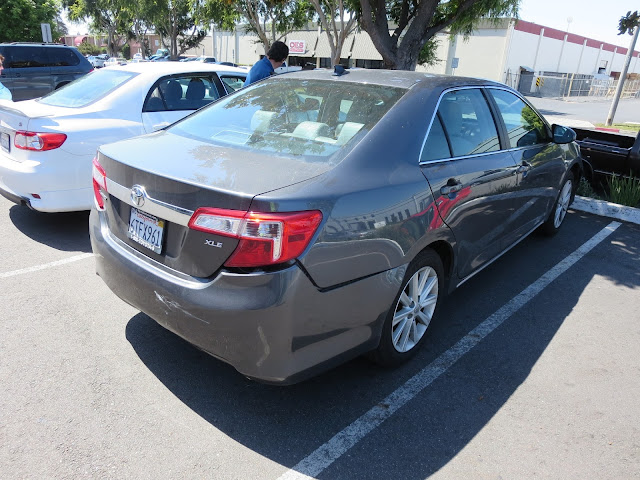 Toyota Camry with rear end damage from collision before repairs at Almost Everything Auto Body.