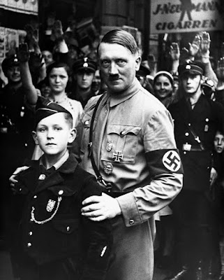 Stealing children's smiles:  How may of these kids understood what Hitler's Nazism was?  How many of the kids in the photos with De Santis understood what Gay, Christian nation or other De Santis topics are?