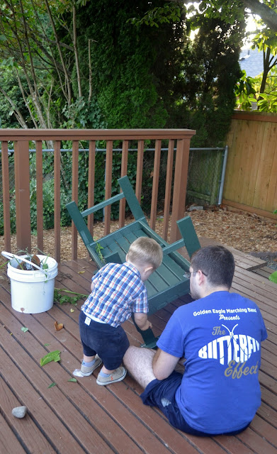 toddler and his dad building a bench