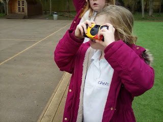 Young girl taking photo on a disposable camera