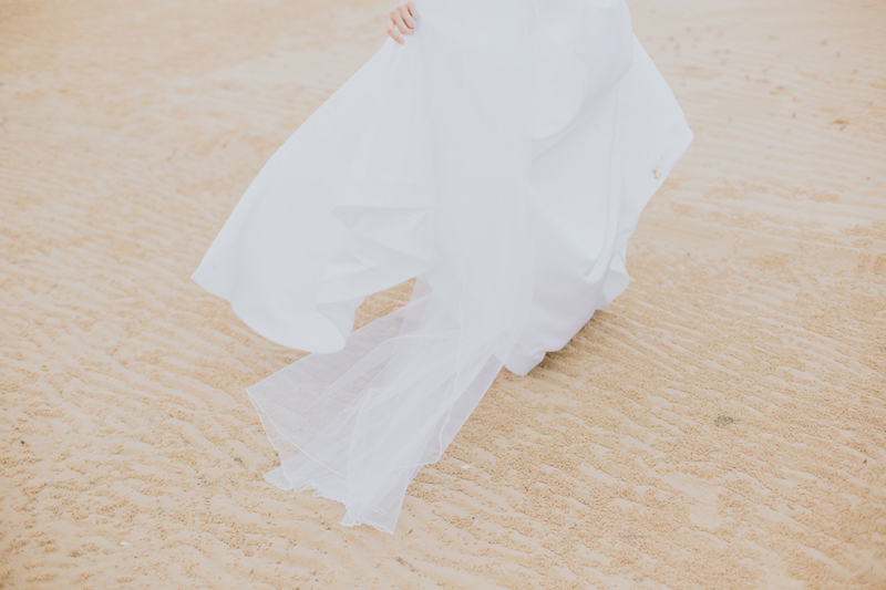 back of bride's dress on sand