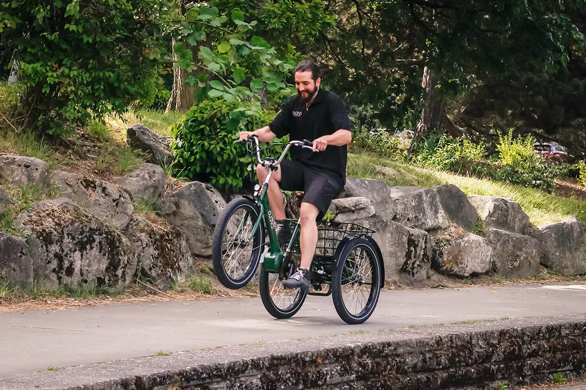 happy man riding an electric tricycle in the park