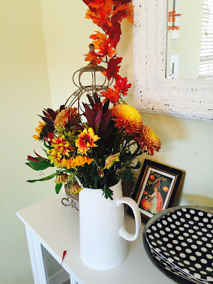 Fall decorated hutch, Ikea shelving, black and white dishes, Orange Halloween dishes