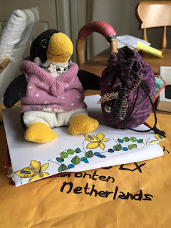 MEme Corina Duyn, small stuffed toy penguin sitting on an envelop, ready to travel abroad