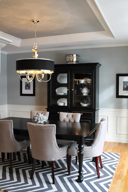 classy dining room black furniture and modern upholstered chairs ties together by zig zag rug 