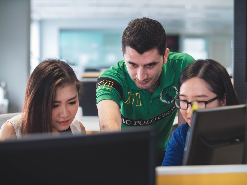 Develop professional relationships. Two women and one man on computer screen. Photo by Mimi Thian on Unsplash