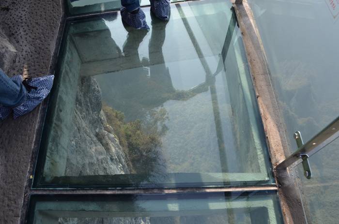 Jutting out from a sheer cliff 1,430 meters high, the glass skywalk in Zhangjiajie National Forest Park offers sightseers terrifying thrills and clear view of the mountains below as they tread nervously across the 60 meter long bridge encircling the vertical cliffs of Tianmen Mountain in Hunan province. The 3ft-wide, 2.5in thick glass walkway is so scary that sightseers are requested to wear cloth slip-ons over their shoes when they cross the skywalk, presumably to make the job easier for the cleaners.