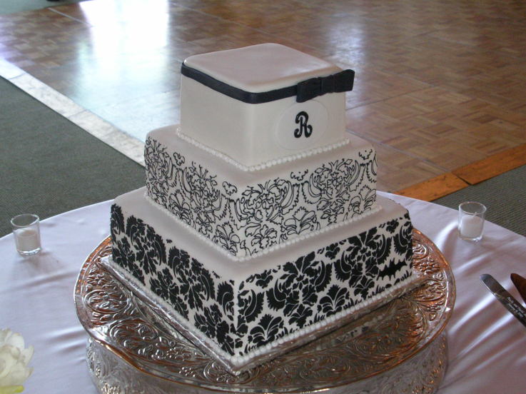 Four tier black and white damask wedding cake with dotted pattern on the top 