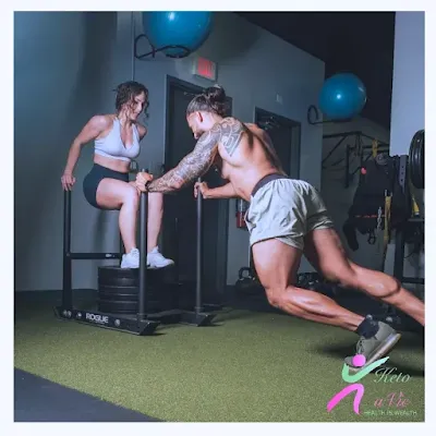 A photo of two people training together for muscle growth and strength