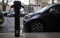 Electric cars are plugged into a charging point in London, Britain, April 7, 2016. (Credit: Reuters/Neil Hall/File Photo) Click to Enlarge.