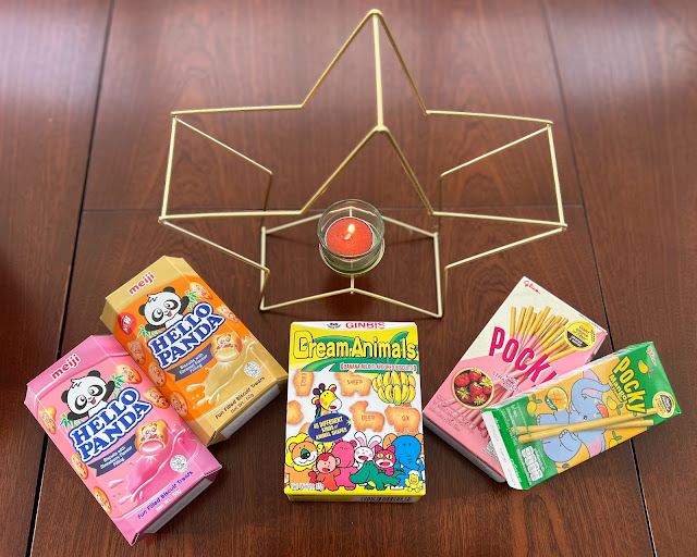 gold coloured star candle feature with asian snacks around