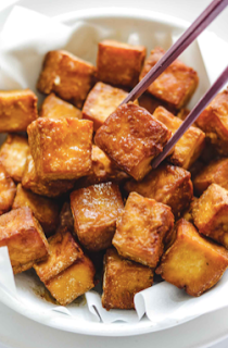 A photo of crispy tofu chunks in a bowl.