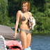 Miley Cyrus lights up a cigarette while soaking up some rays with her pup on Orchard Lake, MI.