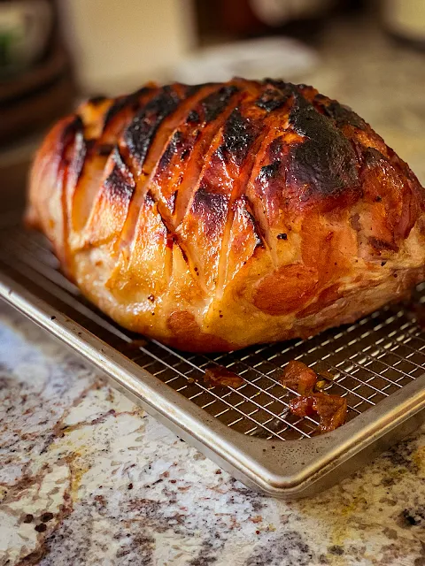 A Whole Bone In Ham recipe is so simple, with no glaze, no studding with cloves and no fuss.  The recipe uses the low and slow method of cooking and a blast of high heat at the end carmalizing the outside.  The results are excellent, juicy, tender, and superb flavor.