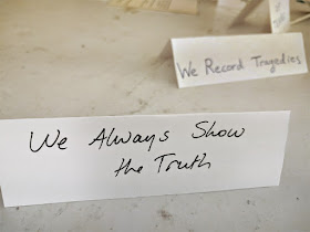 An example of a Value, "We Always Show the Truth" with one in the background reading "We Record Tragedies."