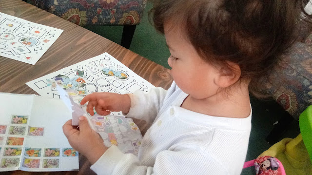 my baby girl working on her Toddler Fine Motor Sticker Practice Page