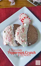 Chocolate Peppermint Crunch Cookies | by Life Tastes Good are rich chocolate cookies dipped in white chocolate and covered in crunchy peppermint candy to give them the taste and feel of Christmas!