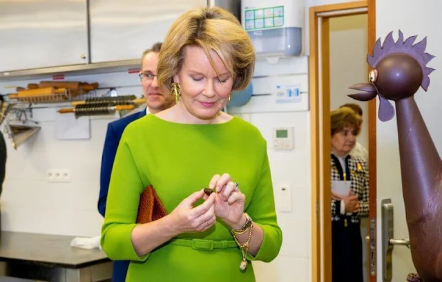 Queen Mathilde wore a neon green, lime green belted midi dress by Natan. Gold leaf earrings