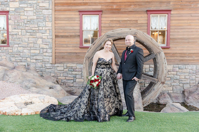 bride and groom portrait in front of water wheel