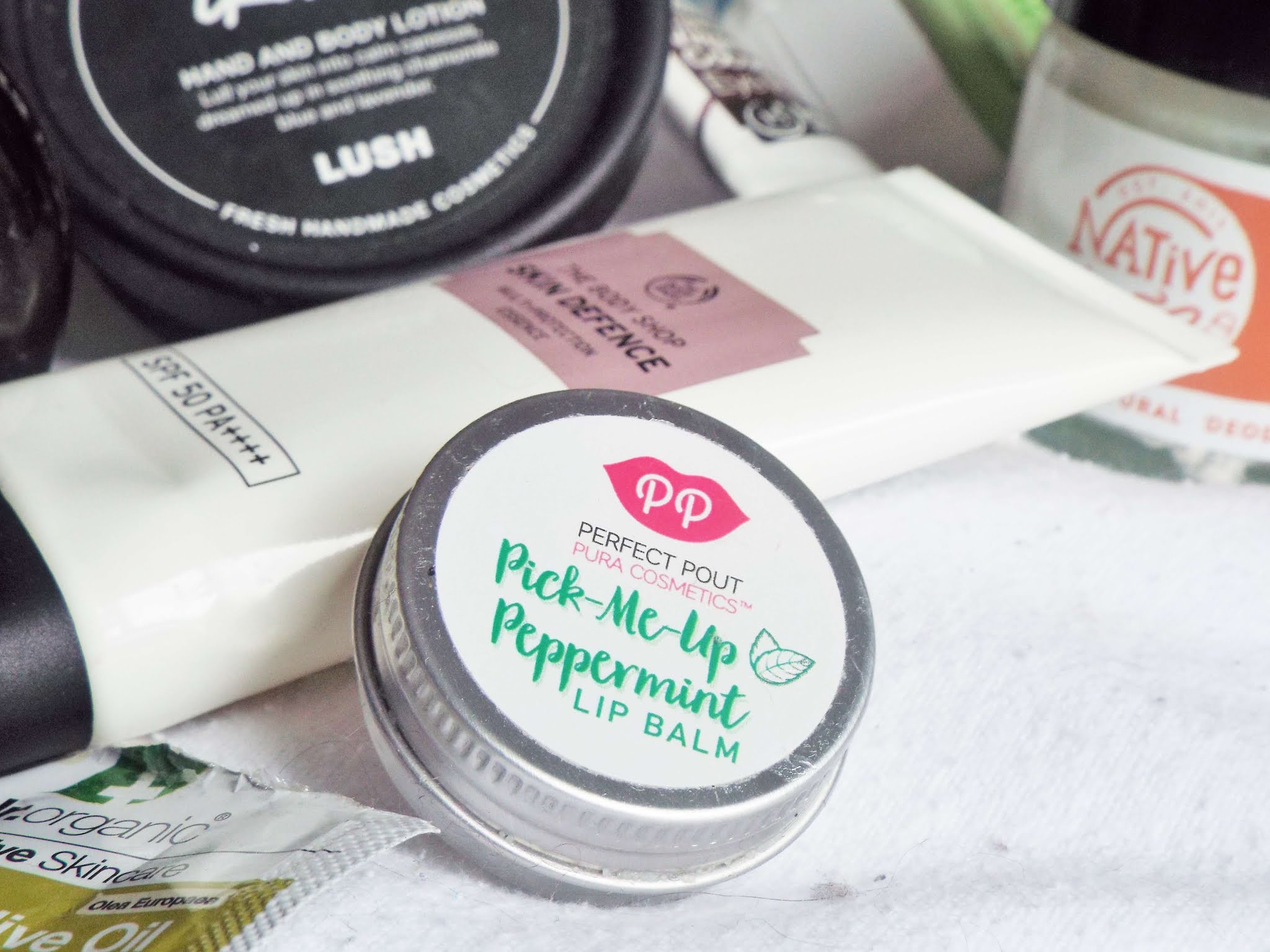 Pura Cosmetics Pick-Me-Up Peppermint Lip Balm, in silver tin, with peppermint green writing on white sticker.