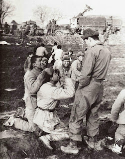Captured Chinese soldiers beg for their lives to a South Korean soldier, thinking they are going to be executed, 1951.
