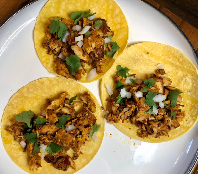 Authentic pork al pastor served in tacos