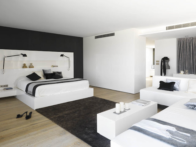 Modern white bedroom with one black wall and carpet 