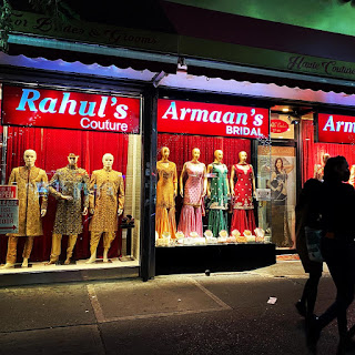 A shop window on 74th Street in Jackson Heights features South Asian fashion.