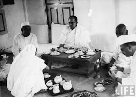 Pro-Japanese, anti-British Indian Nationalist leader Subhas Chandra Bose (C) enjoying a meal at Bardoli Ashram on his way to the 51st Indian National Congress during WWII in 1940.