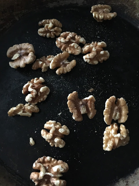 roasting walnuts in a pan