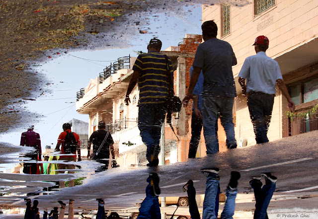 55 Photography Tips / Reflection of Photographers out on a Group Photowalk in a Water Puddle