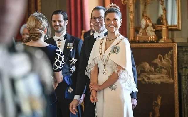 Queen Silvia wore a Padme pink gown by Georg et Arend. Princess Victoria wore a feather cape gown by Toteme