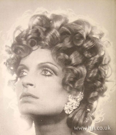 tousled type of hairstyle popularized by surfers in the 1960s and 1970s.
