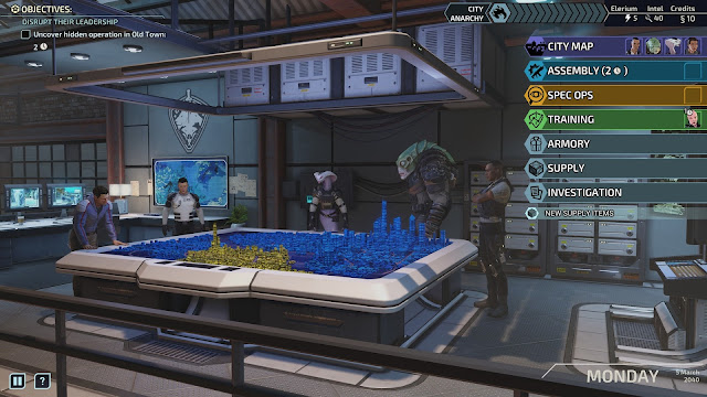Chimera Squad stands around the operations table. Whisper, the human who acts as your comm officer, standing on the far left side, has his hands on the table, next to his right is the pacifist human psionic Shelter standing loosely with his arms to his sides, located in the middle it the snake-like viper Torque who is standing similarly, next to her is the muton hybrid Axiom and continues the simalar standing posture and the last agent on the left is the human pistoleer Blueblood who is standing with his arms crossed looking on. The command table has one district in its bottom center in yellow and the other eight tiles are all blue.