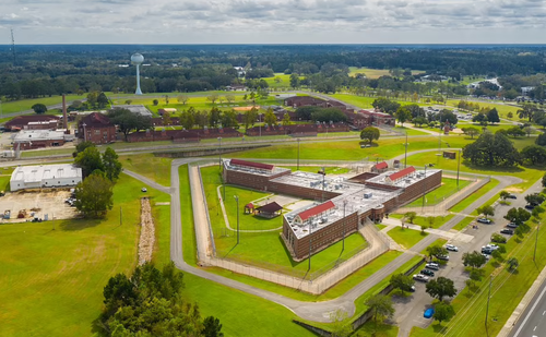 FCI Tallahassee, potentially Maxwell's home until at least July 17, 2037, is surrounded by a maze of 30 ft fences and cameras but the elegant, red-brick building behind the rolls of jagged razor wire looks more akin to a high school or college campus