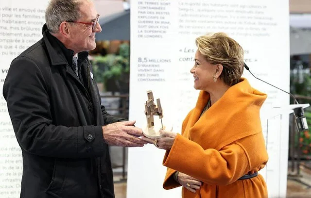 Grand Duchess Maria Teresa wore a Hooded orange cashmere coat by Dusan. Short open cashmere coat with hood