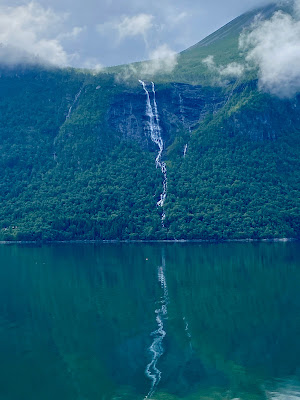 waterfall reflection in fjords near Åndalsnes, Norway
