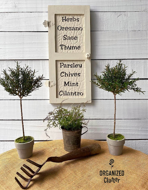 Photo of a garage sale mini door upcycled as herb decor.