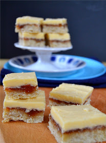 cookie bars topped with rhubarb jam and a custard flavoured icing