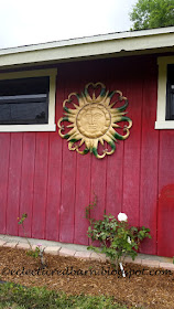 Eclectic Red Barn: Metal sun hanging on the barn