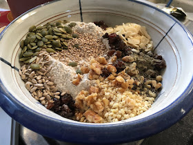 Bowl with dry flours, dried fruit, nut and seed for bread by Corina Duyn