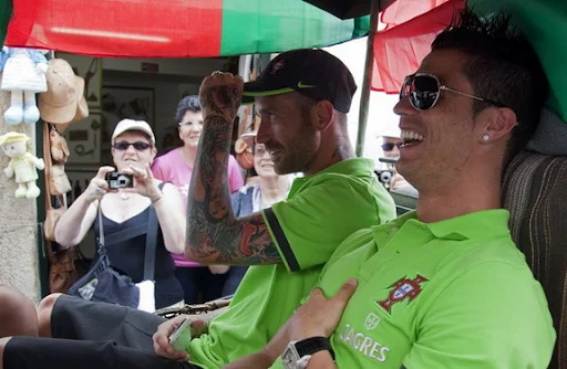 Cristiano Ronaldo sits on a wagon as the Portugal team is paraded through downtown Obidos