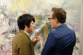 Making a point, Chinese Artist He Zige discusses his work one on one - Photos By Kent Johnson for Street Fashion Sydney.